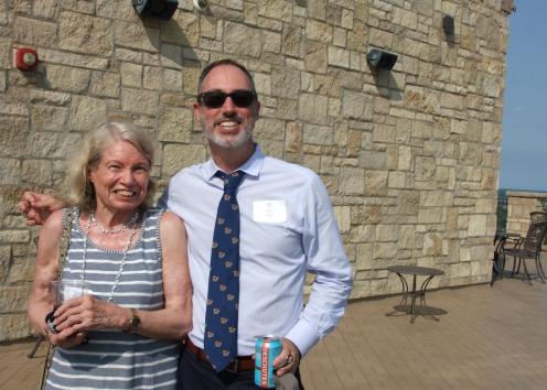 History professors at Convocation event smile for photo outside on Oread balcony