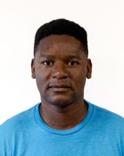 an image of a man in a blue shirt looking at the camera 