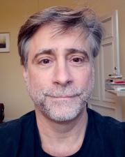 Image of a man looking into the camera for 