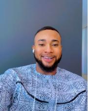 an image of a man in a blue shirt smiling at the camera 