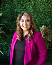 A woman wearing a fuchsia blazer 