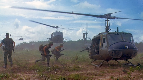 Soldiers running to get into a helicopter 