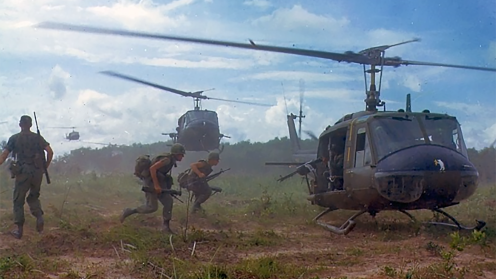 Soldiers running to get into a helicopter